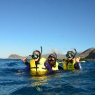 a man standing next to a body of water