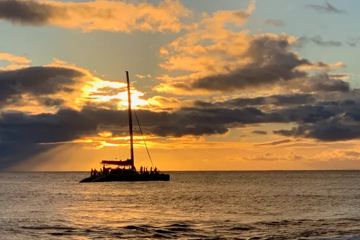 a large ship in the ocean on a cloudy day
