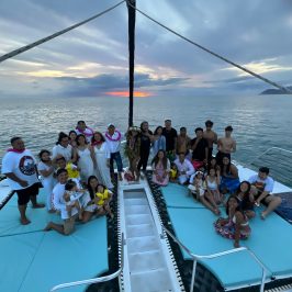 a group of people in a boat on a body of water