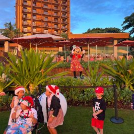 a group of people playing football in front of a building