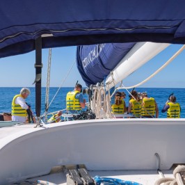 a group of people on a boat in the water