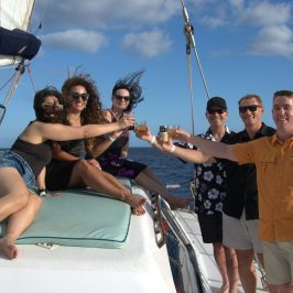 a group of people on a boat posing for the camera