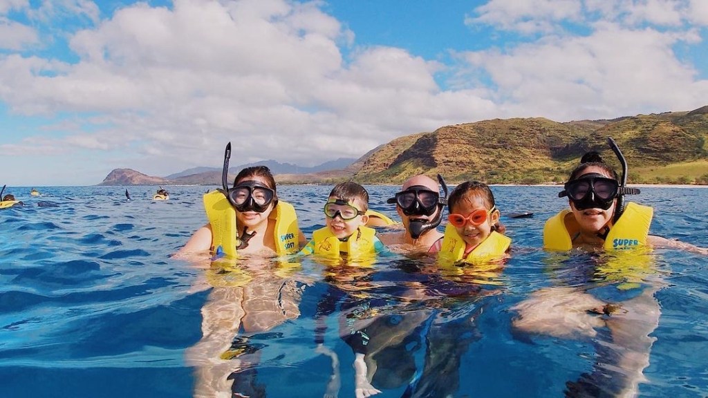 a couple of people that are standing in the water